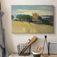 Canvas art print detailing a landscape of ripened wheat in an open natural setting, displayed in a softly lit workspace setting