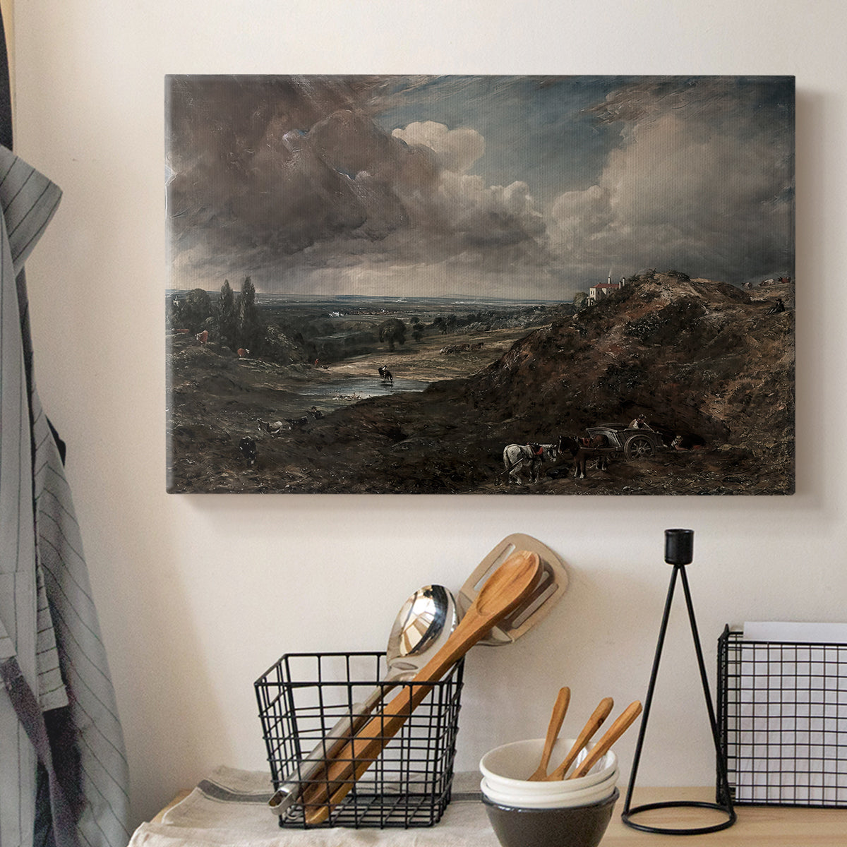 Canvas art print detailing a countryside view emphasizing water and sky, displayed in a softly lit workspace setting