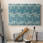 Canvas art print detailing a repeating motif featuring tulips and organic forms, displayed in a softly lit workspace setting