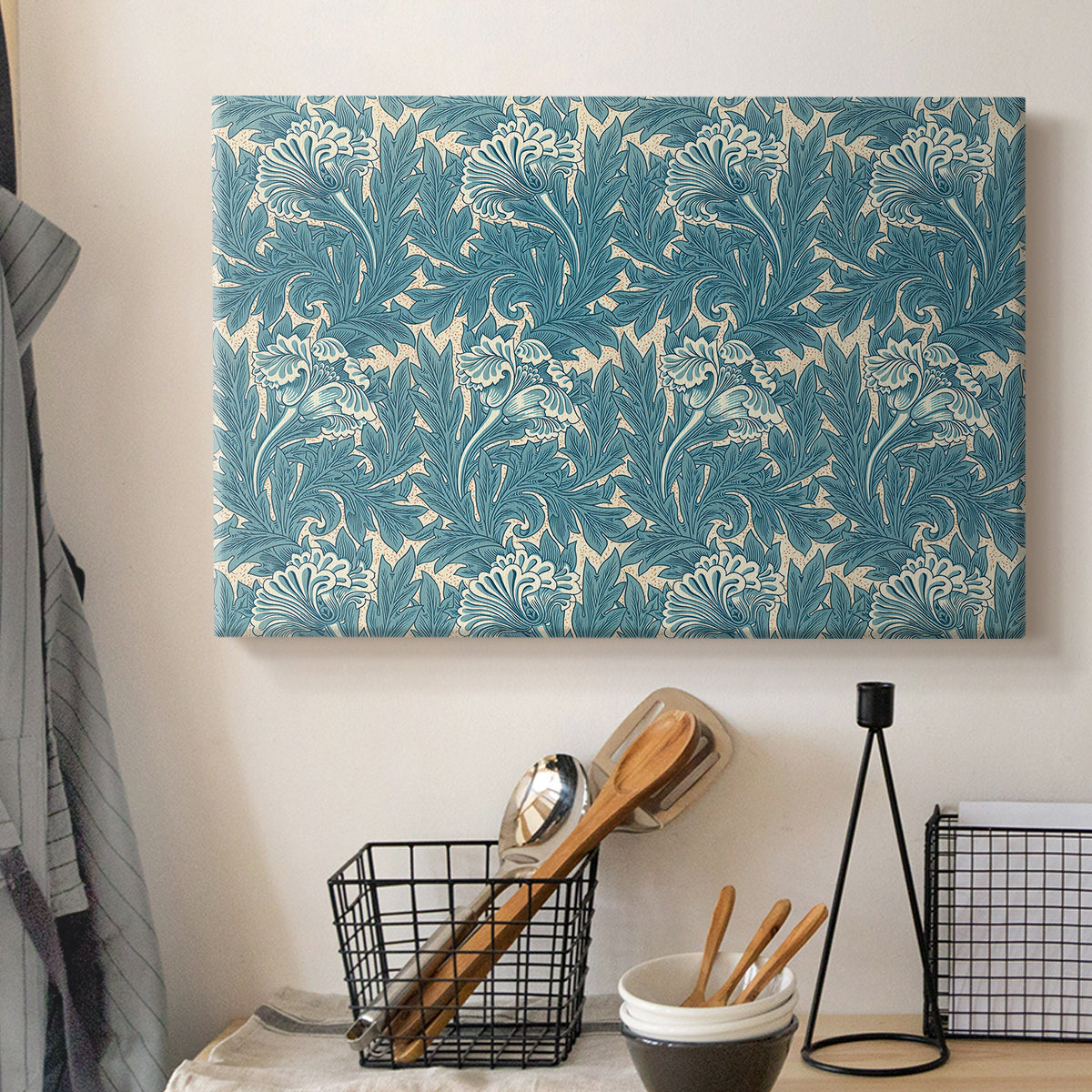Canvas art print detailing a repeating motif featuring tulips and organic forms, displayed in a softly lit workspace setting
