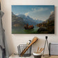 Canvas art print detailing a romantic landscape of boats on calm water beneath steep cliffs and mountains, displayed in a softly lit workspace setting