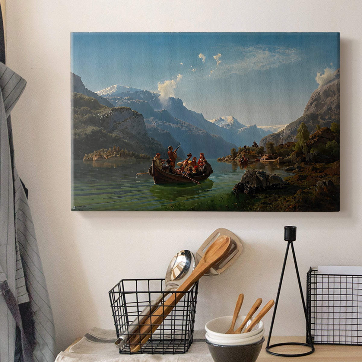 Canvas art print detailing a romantic landscape of boats on calm water beneath steep cliffs and mountains, displayed in a softly lit workspace setting