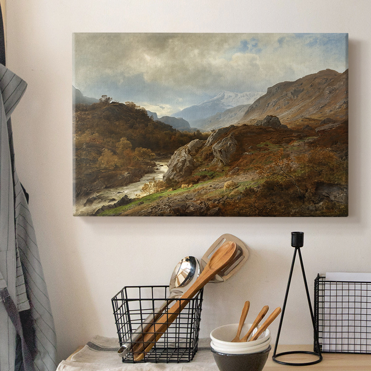 Canvas art print detailing a romantic depiction of mountainous environment, displayed in a softly lit workspace setting