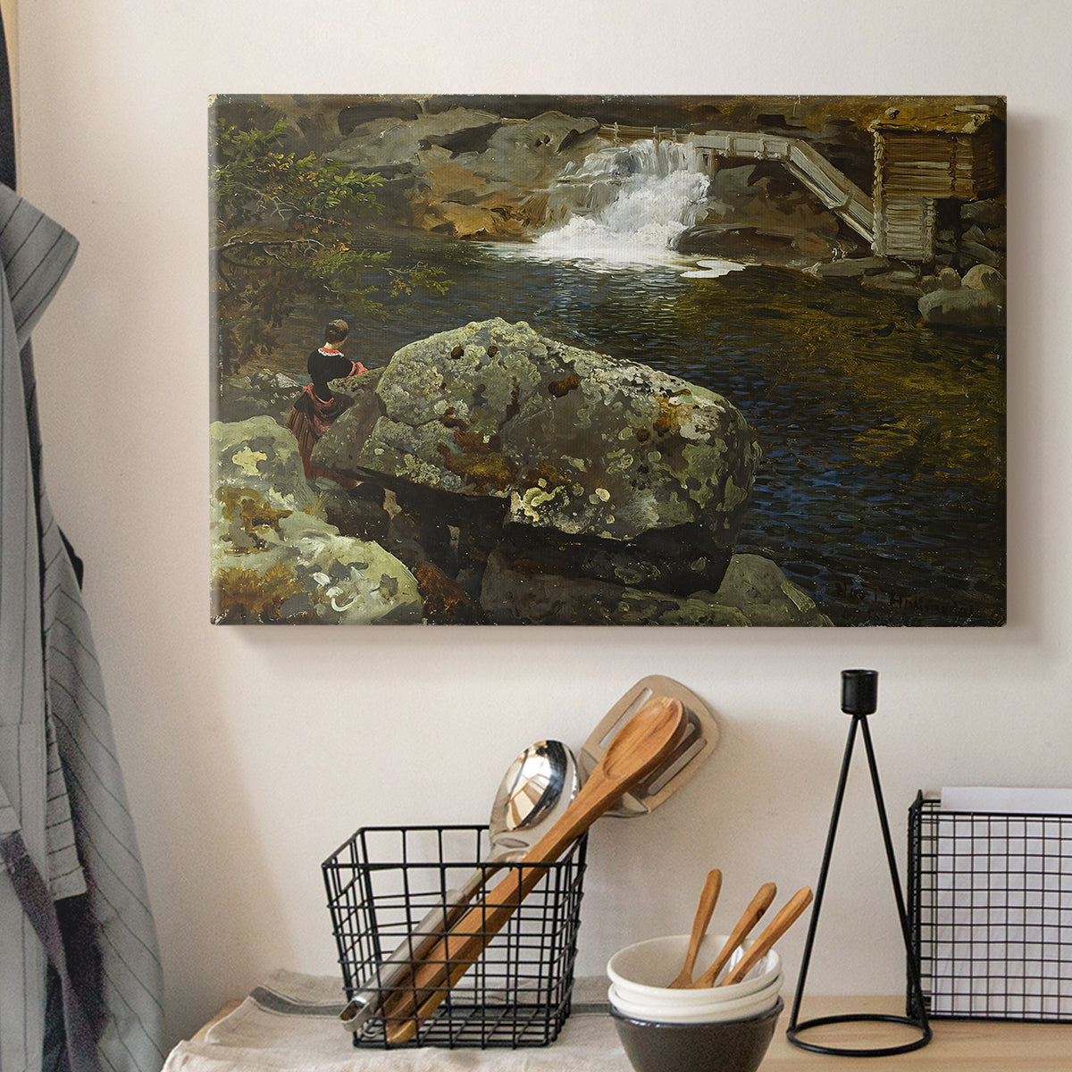 Canvas art print detailing a peaceful natural setting with mill and still water, displayed in a softly lit workspace setting