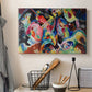 Canvas art print detailing an abstract arrangement with strong movement and color interaction, displayed in a softly lit workspace setting