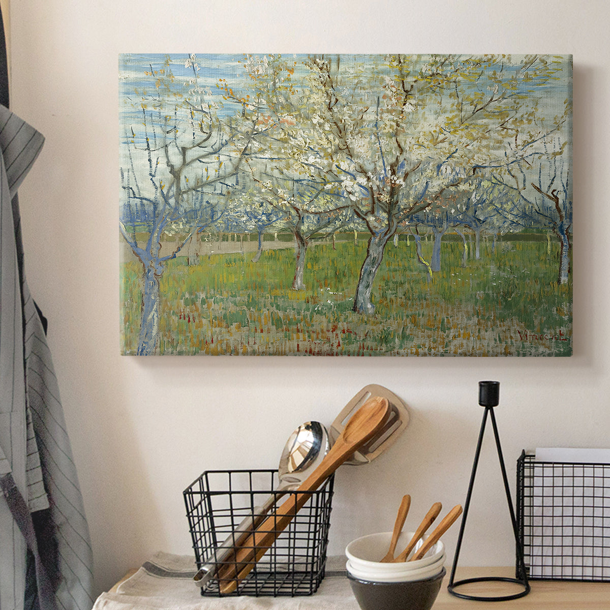 Canvas art print detailing a stylized orchard composition with delicate tones, displayed in a softly lit workspace setting