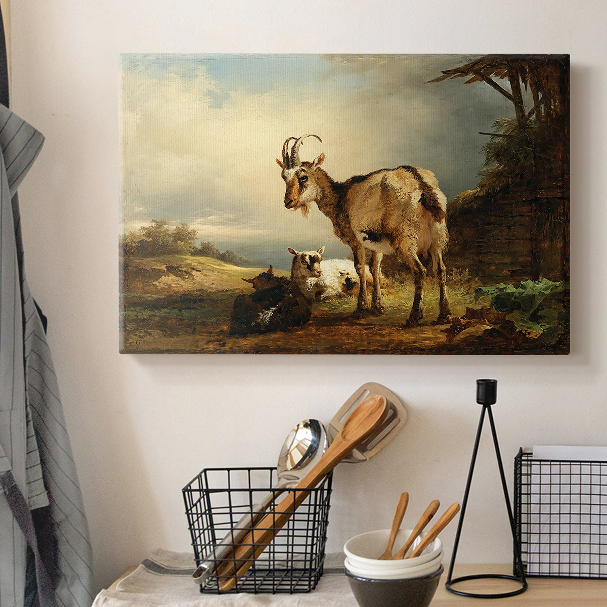 Canvas art print detailing realistic goats in field, displayed in a softly lit workspace setting