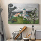Canvas art print detailing a colorful scene of a villa among trees and vegetation, displayed in a softly lit workspace setting