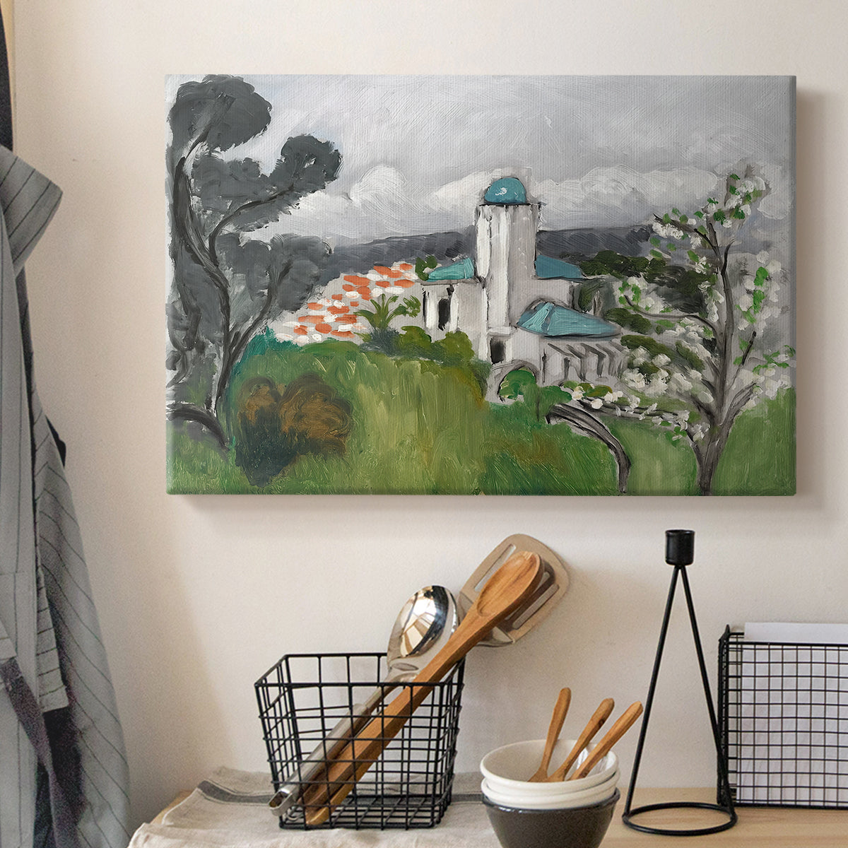 Canvas art print detailing a colorful scene of a villa among trees and vegetation, displayed in a softly lit workspace setting