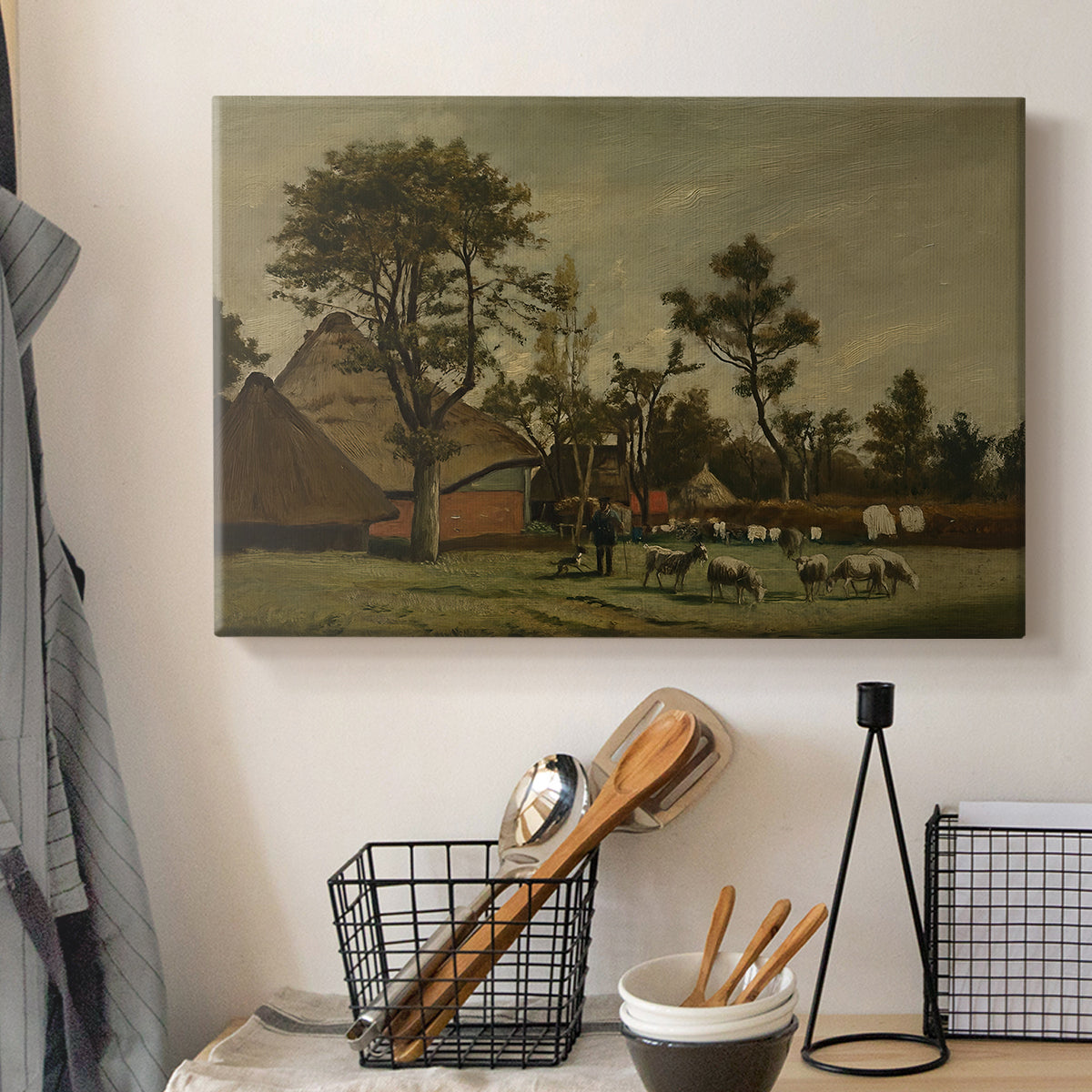 Canvas art print detailing a countryside composition with architecture and animals, displayed in a softly lit workspace setting