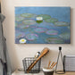 Canvas art print detailing a close-up of aquatic plants in still water, displayed in a softly lit workspace setting