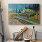 Canvas art print detailing a countryside composition combining flowering trees and structure, displayed in a softly lit workspace setting
