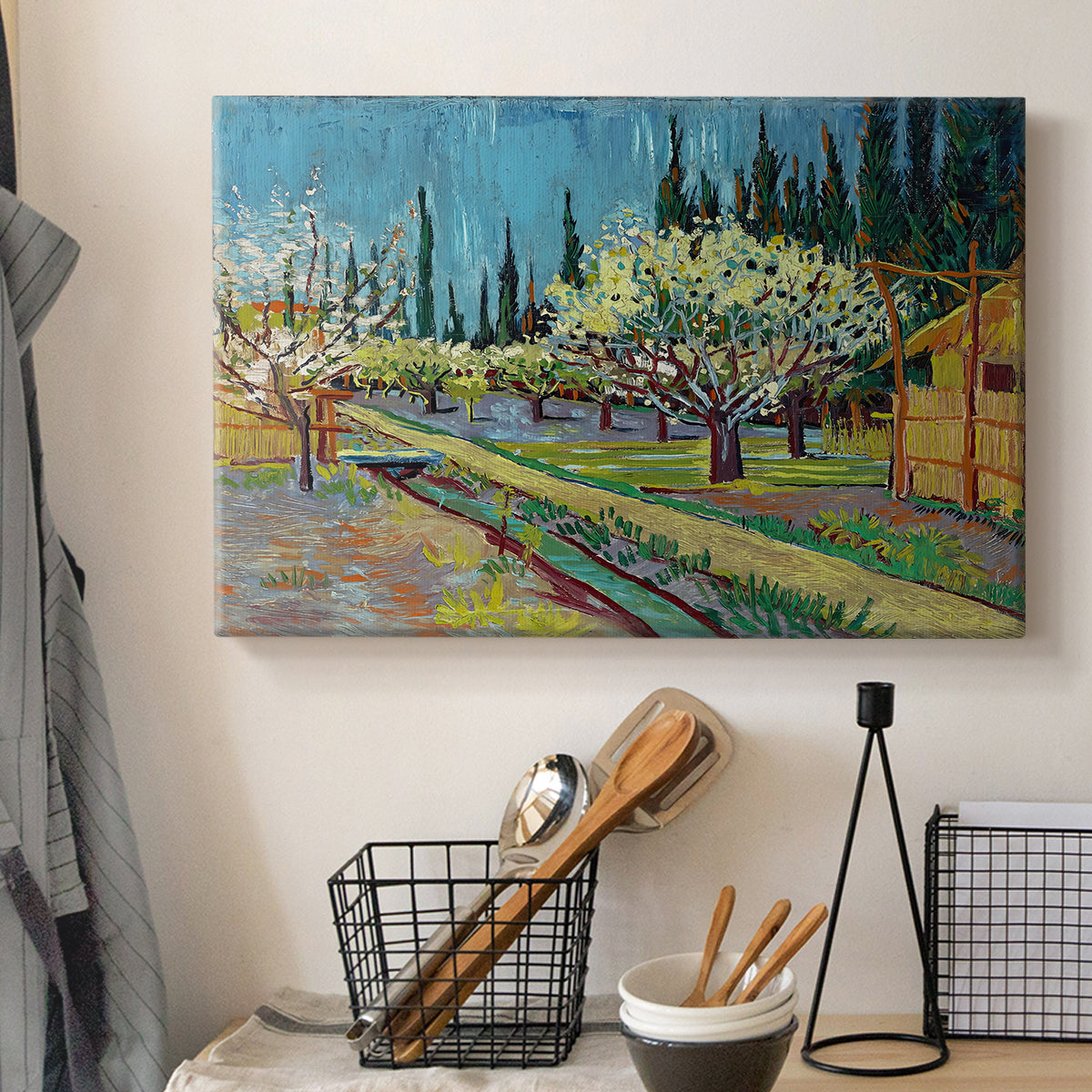 Canvas art print detailing a countryside composition combining flowering trees and structure, displayed in a softly lit workspace setting