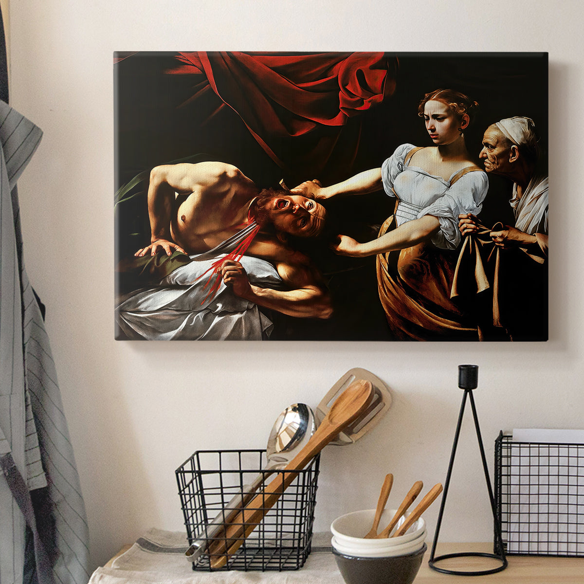 Canvas art print detailing a violent religious narrative with strong contrast of light and shadow, displayed in a softly lit workspace setting
