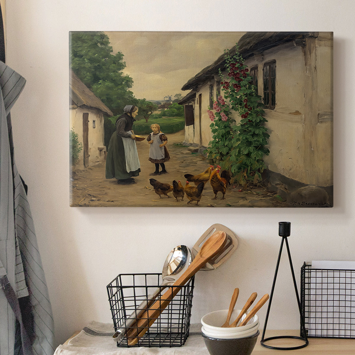 Canvas art print detailing a countryside visit scene with figures in front of rustic buildings, displayed in a softly lit workspace setting
