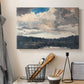Canvas art print detailing a solitary boat set within natural woodland environment, displayed in a softly lit workspace setting