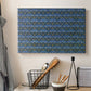 Canvas art print detailing a textile-style surface filled with small leaves and blossoms, displayed in a softly lit workspace setting