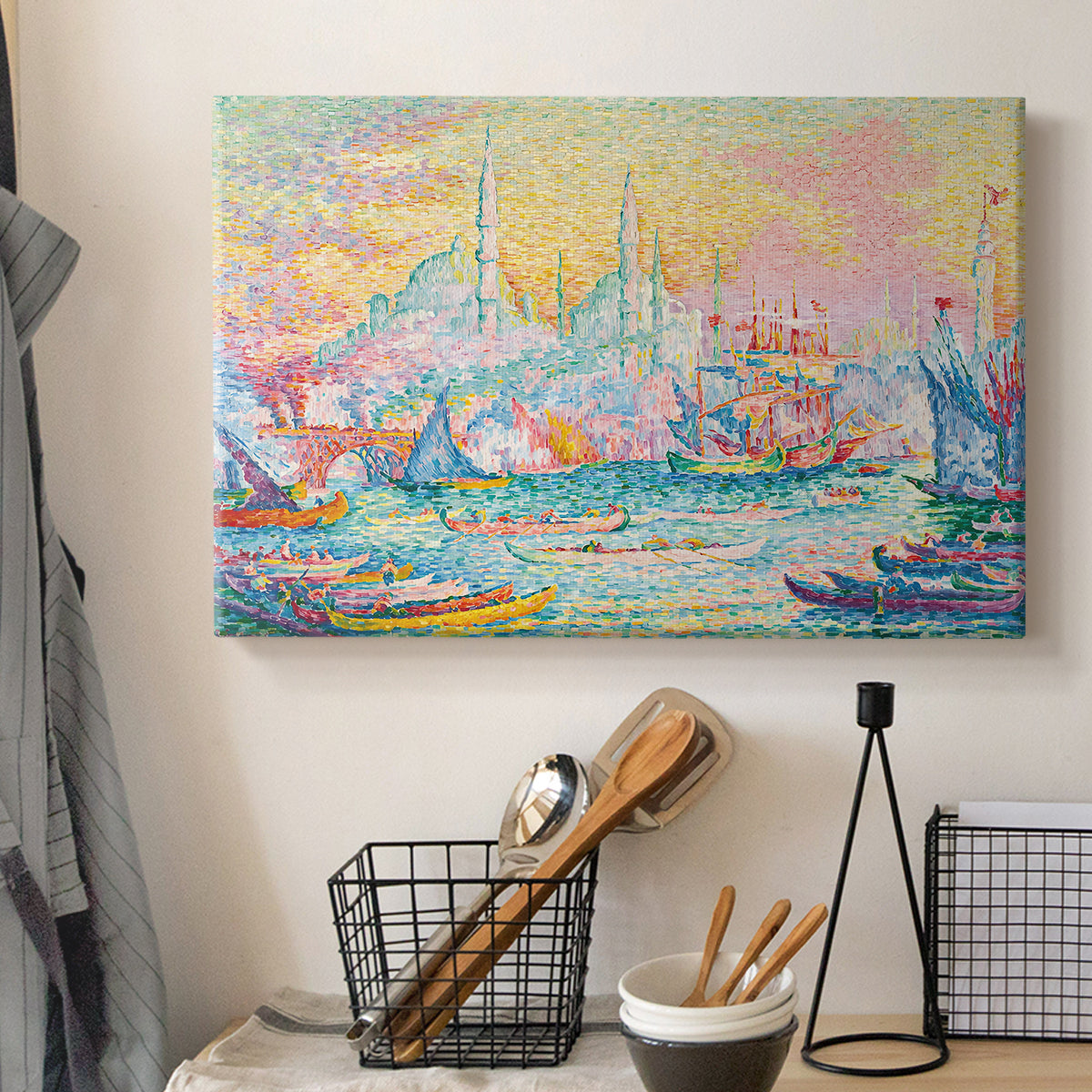 Canvas art print detailing a coastal cityscape, displayed in a softly lit workspace setting