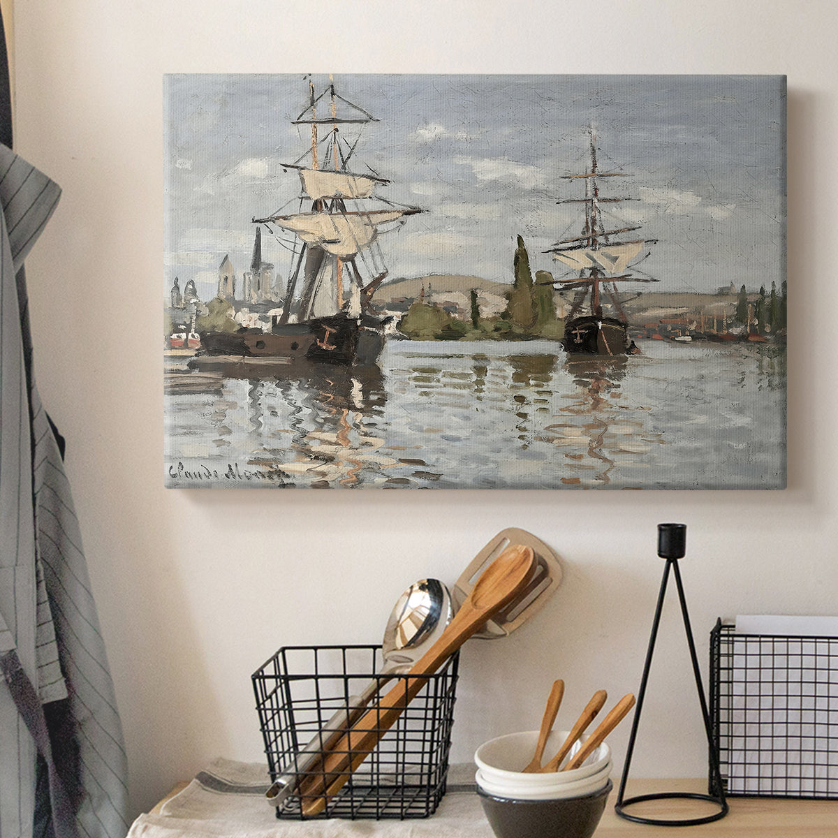 Canvas art print detailing a nautical landscape with vessels resting on calm water, displayed in a softly lit workspace setting
