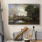 Canvas art print detailing a countryside view with mill and canal, displayed in a softly lit workspace setting