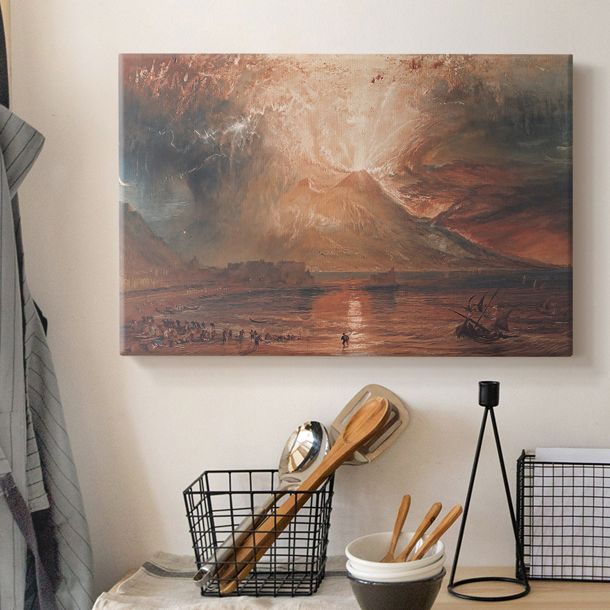 Canvas art print detailing a landscape showing volcanic activity, displayed in a softly lit workspace setting