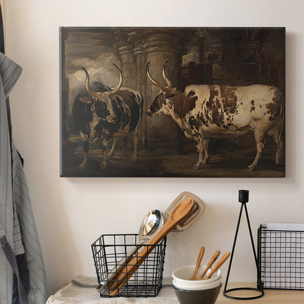 Canvas art print detailing a pastoral scene with two oxen in field, displayed in a softly lit workspace setting