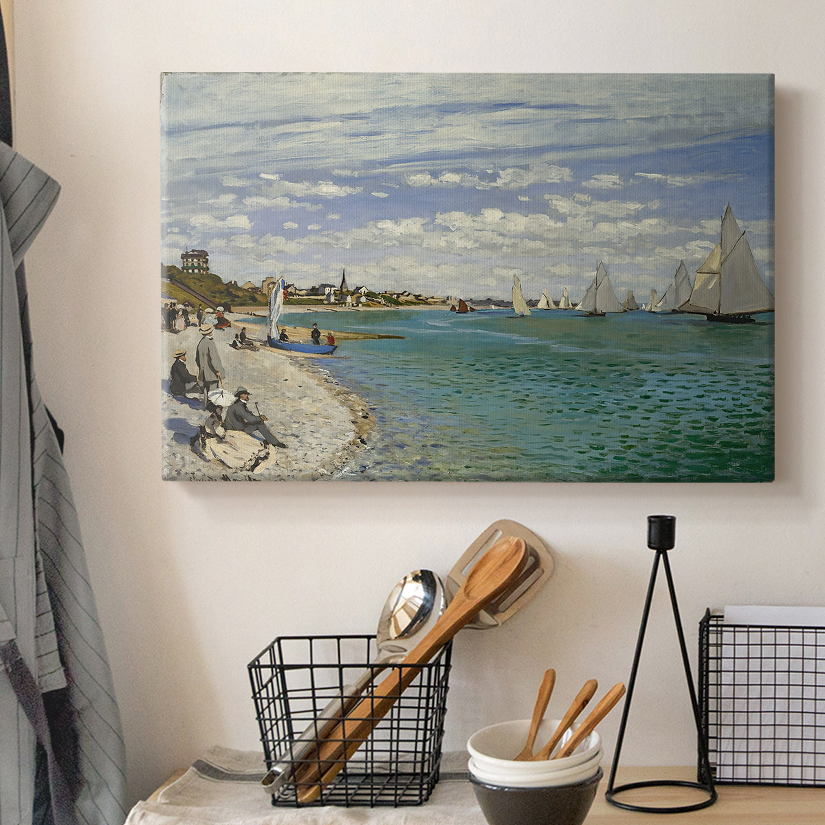 Canvas art print detailing a nautical scene with boats racing near seaside town, displayed in a softly lit workspace setting