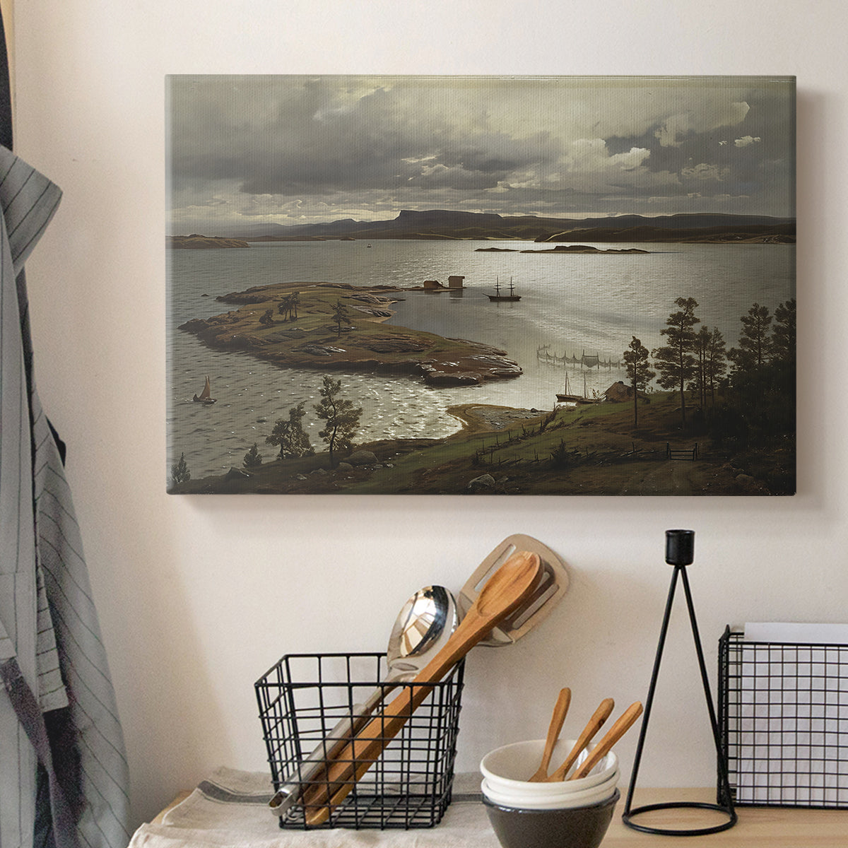 Canvas art print detailing a serene Nordic landscape with fjord and natural light, displayed in a softly lit workspace setting