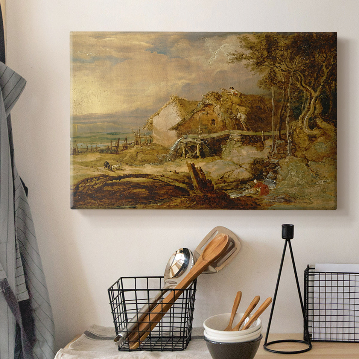 Canvas art print detailing a landscape featuring mill and natural terrain, displayed in a softly lit workspace setting