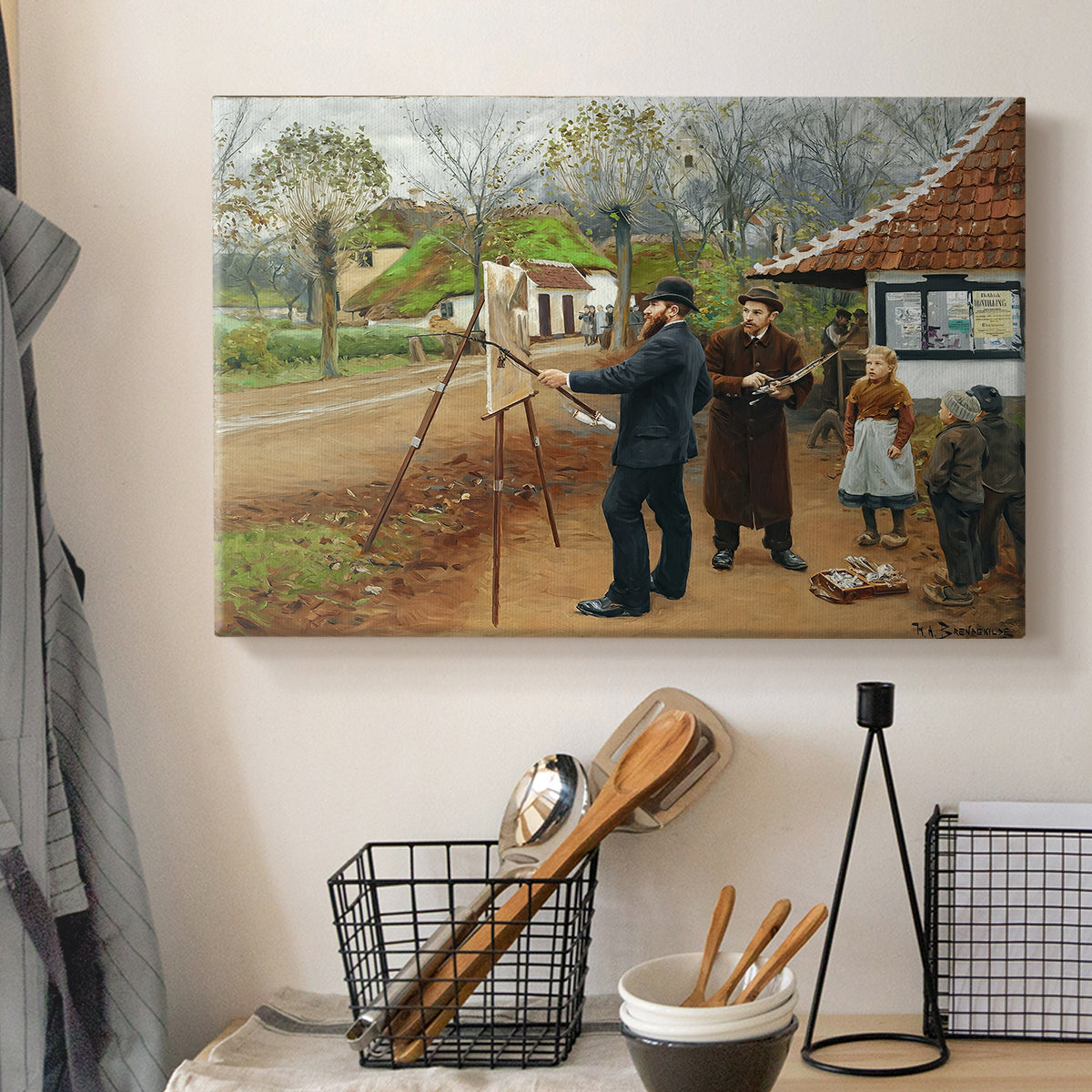 Canvas art print detailing an everyday rural life scene with figures near buildings, displayed in a softly lit workspace setting