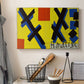 Canvas art print detailing a graphic artwork featuring abstract forms and design elements, displayed in a softly lit workspace setting