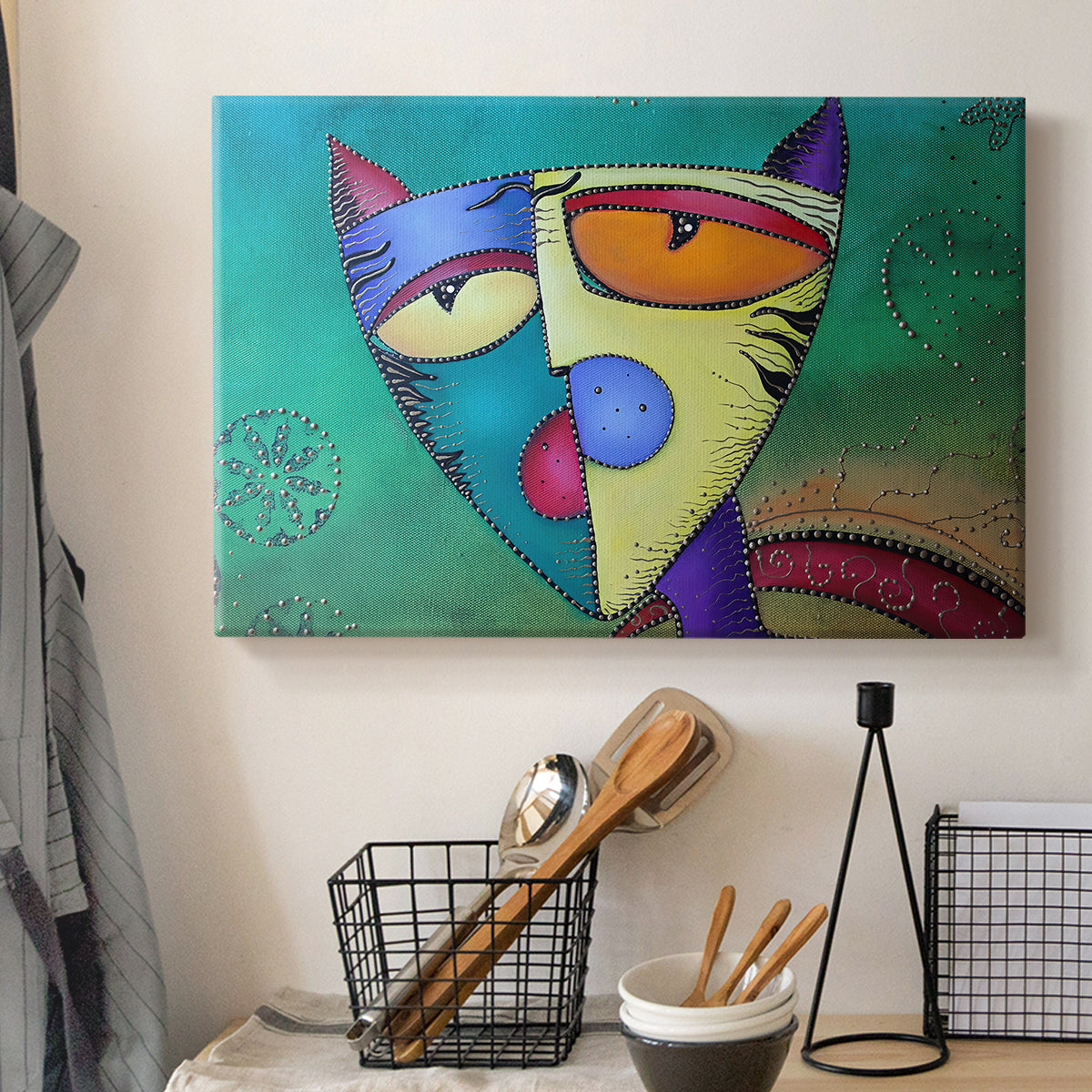 Canvas art print detailing a stylized cat with symmetry, displayed in a softly lit workspace setting