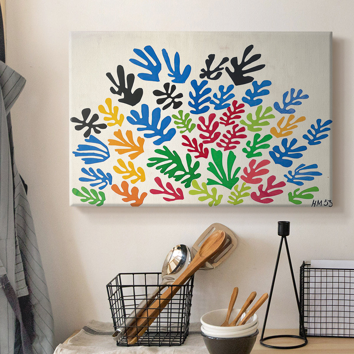 Canvas art print detailing a stylized collage resembling leaves, displayed in a softly lit workspace setting