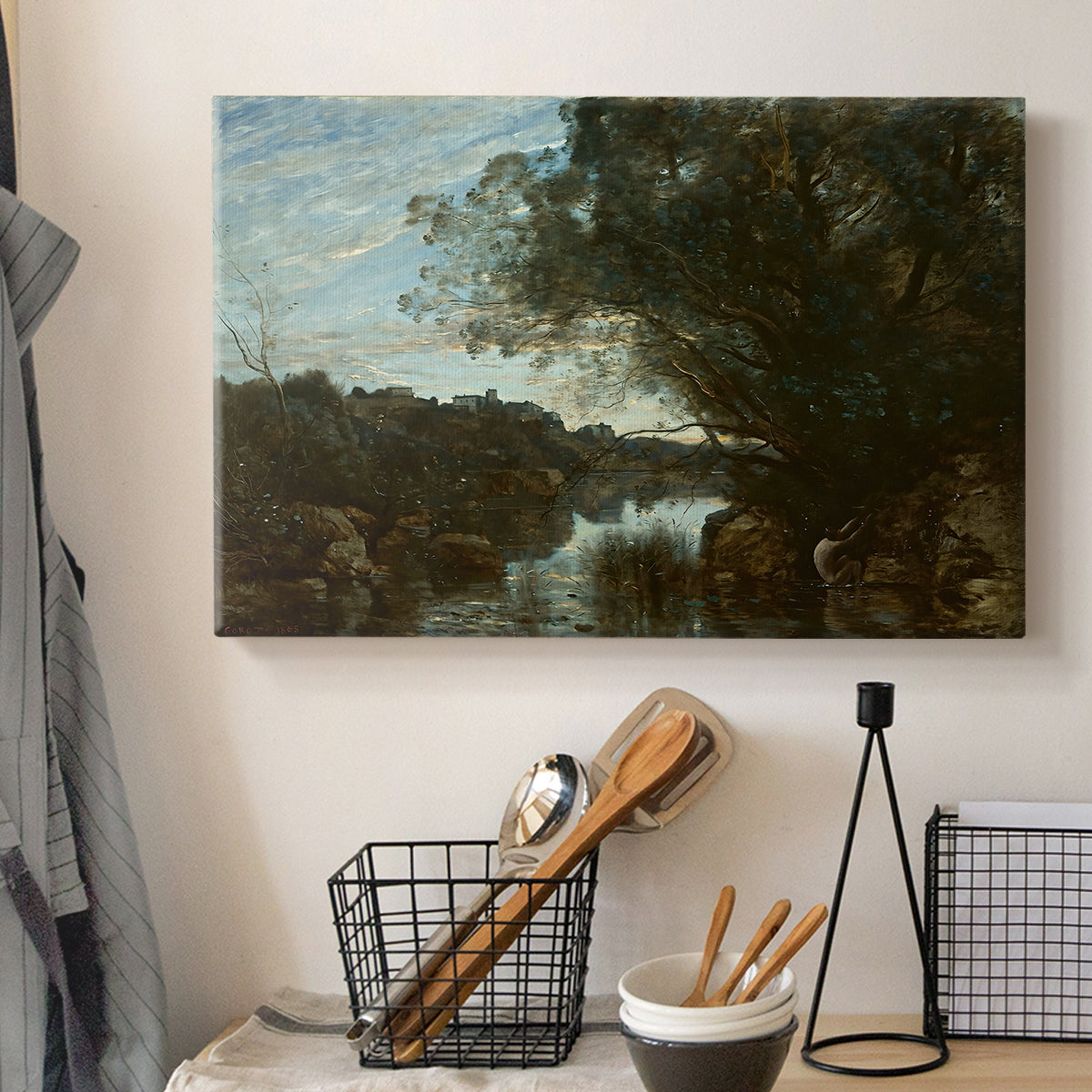 Canvas art print detailing a tranquil setting with water, trees, and horizon, displayed in a softly lit workspace setting