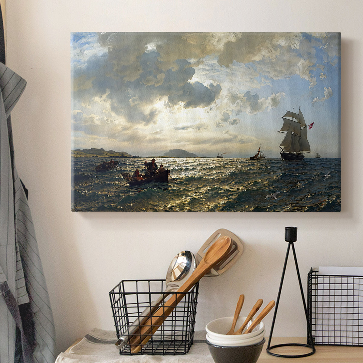 Canvas art print detailing an atmospheric coastal view with motion in sky and sea, displayed in a softly lit workspace setting