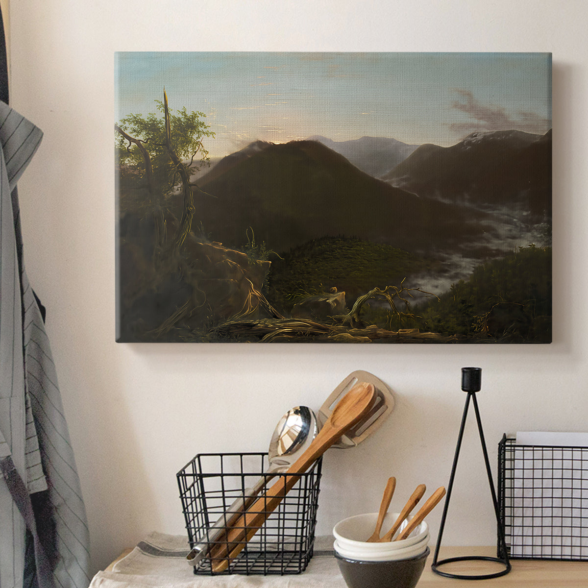 Canvas art print detailing a natural mountain scene illuminated by early morning light, displayed in a softly lit workspace setting