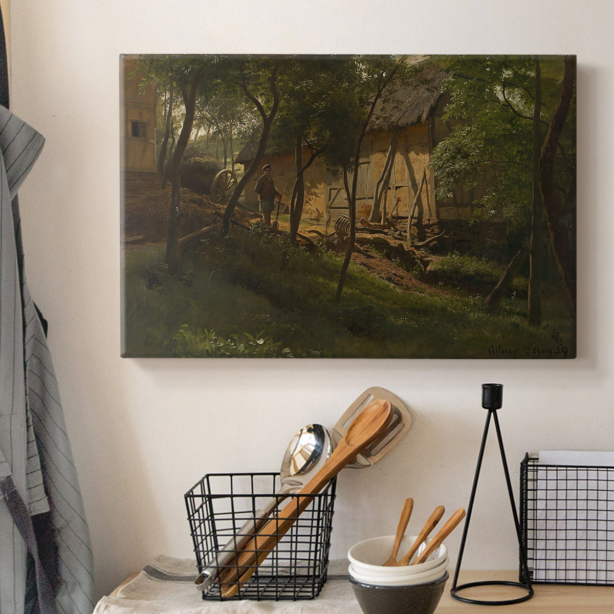 Canvas art print detailing a rural composition with buildings nestled among greenery, displayed in a softly lit workspace setting
