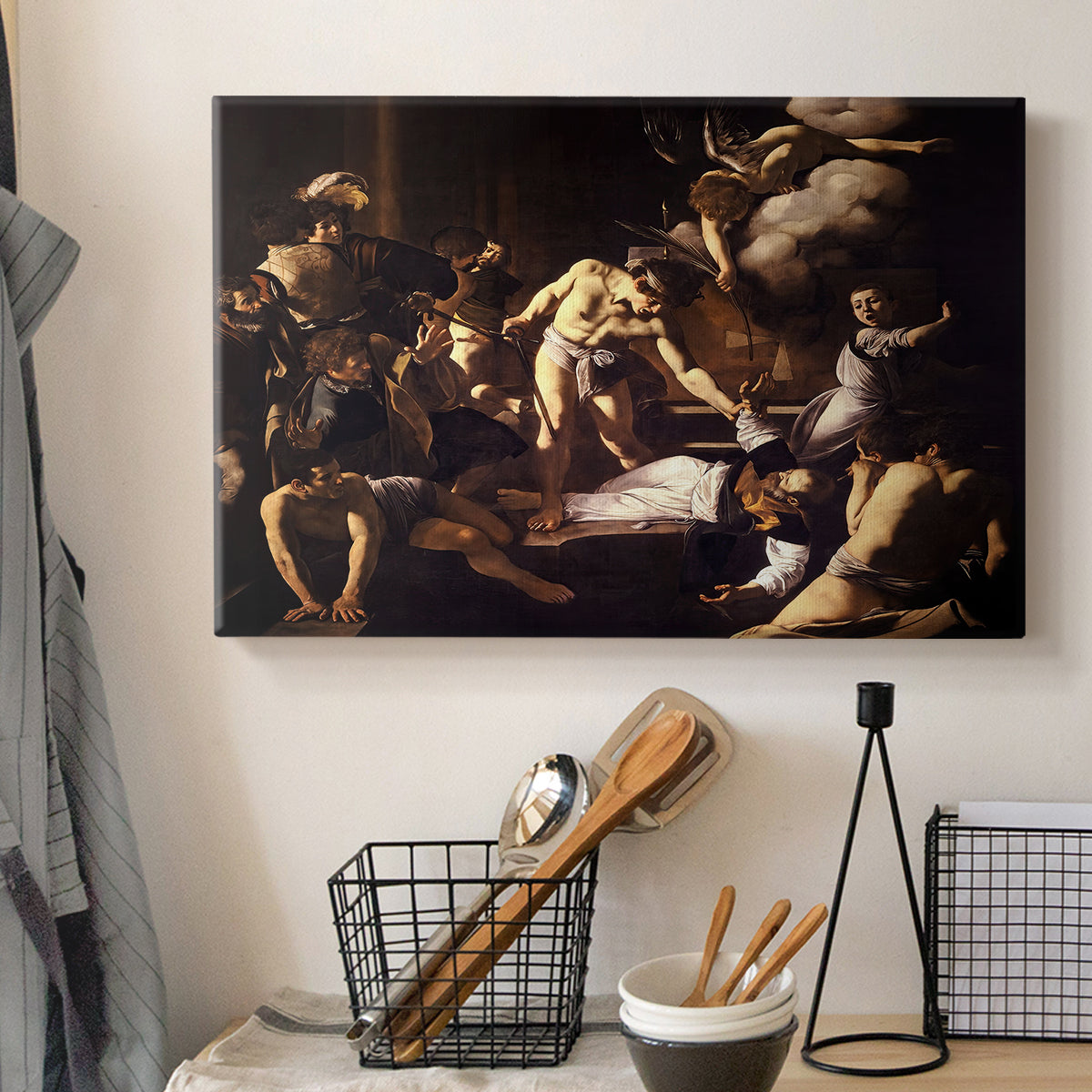 Canvas art print detailing a Baroque composition of movement and emotion during martyrdom, displayed in a softly lit workspace setting