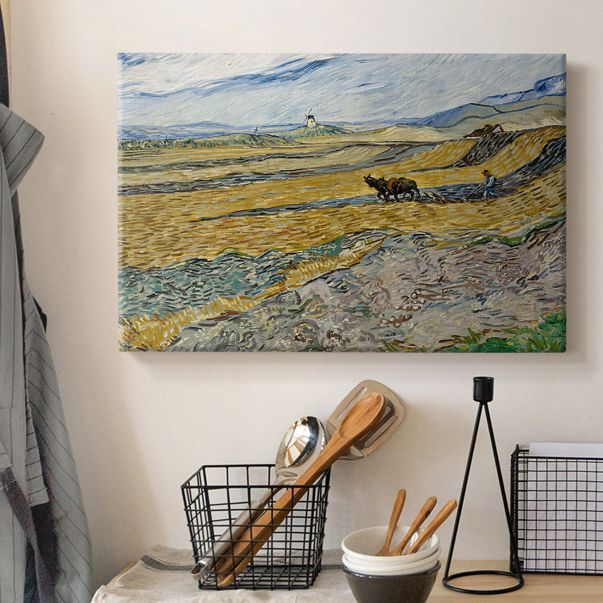 Canvas art print detailing a countryside composition showing agricultural labor in enclosed field, displayed in a softly lit workspace setting
