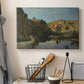 Canvas art print detailing a pastoral setting with water cutting through rugged terrain, displayed in a softly lit workspace setting