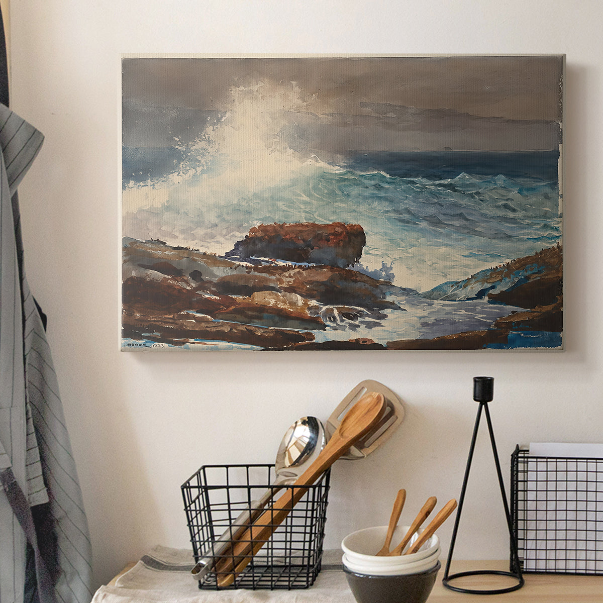 Canvas art print detailing a shoreline view with surf and coastal elements, displayed in a softly lit workspace setting