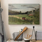 Canvas art print detailing an urban work environment with figures and factory, displayed in a softly lit workspace setting