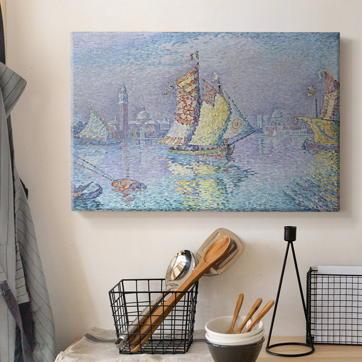 Canvas art print detailing a maritime view with sailboat, displayed in a softly lit workspace setting