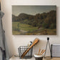 Canvas art print detailing a natural setting with vegetation and soft atmospheric light, displayed in a softly lit workspace setting