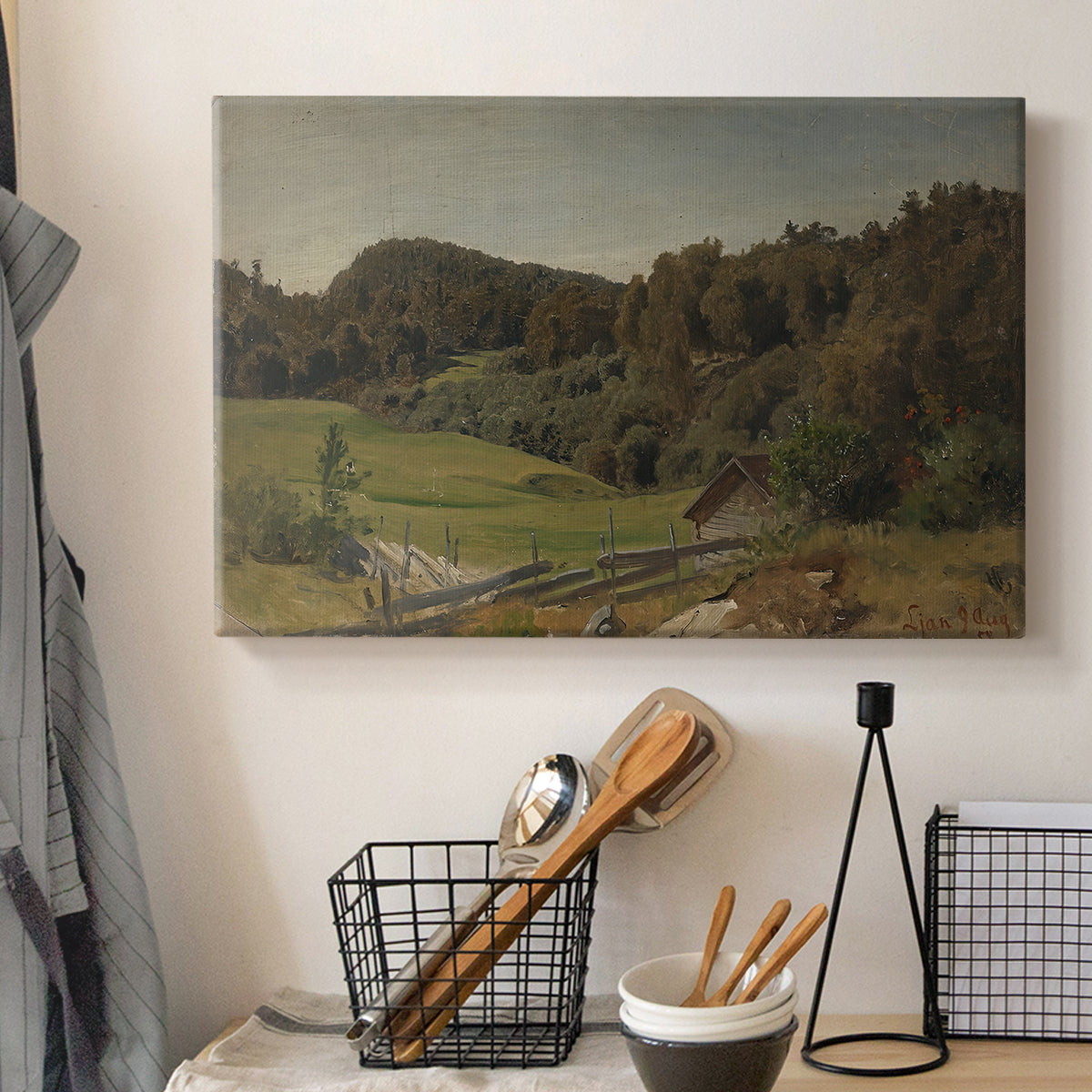 Canvas art print detailing a natural setting with vegetation and soft atmospheric light, displayed in a softly lit workspace setting