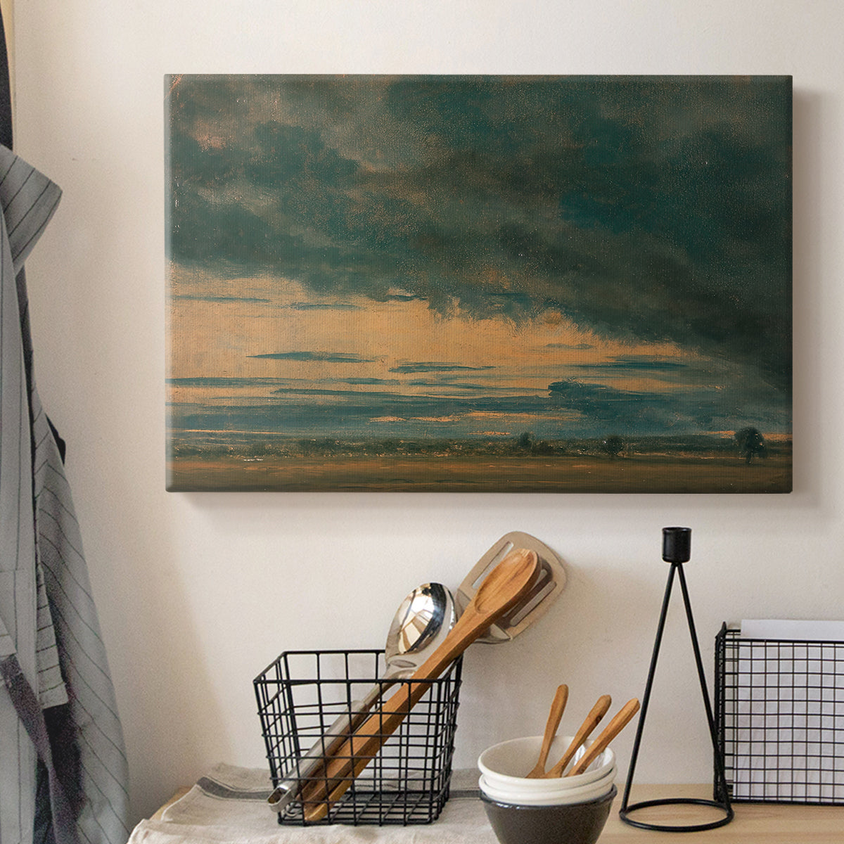Canvas art print detailing a minimal landscape focusing on clouds, displayed in a softly lit workspace setting