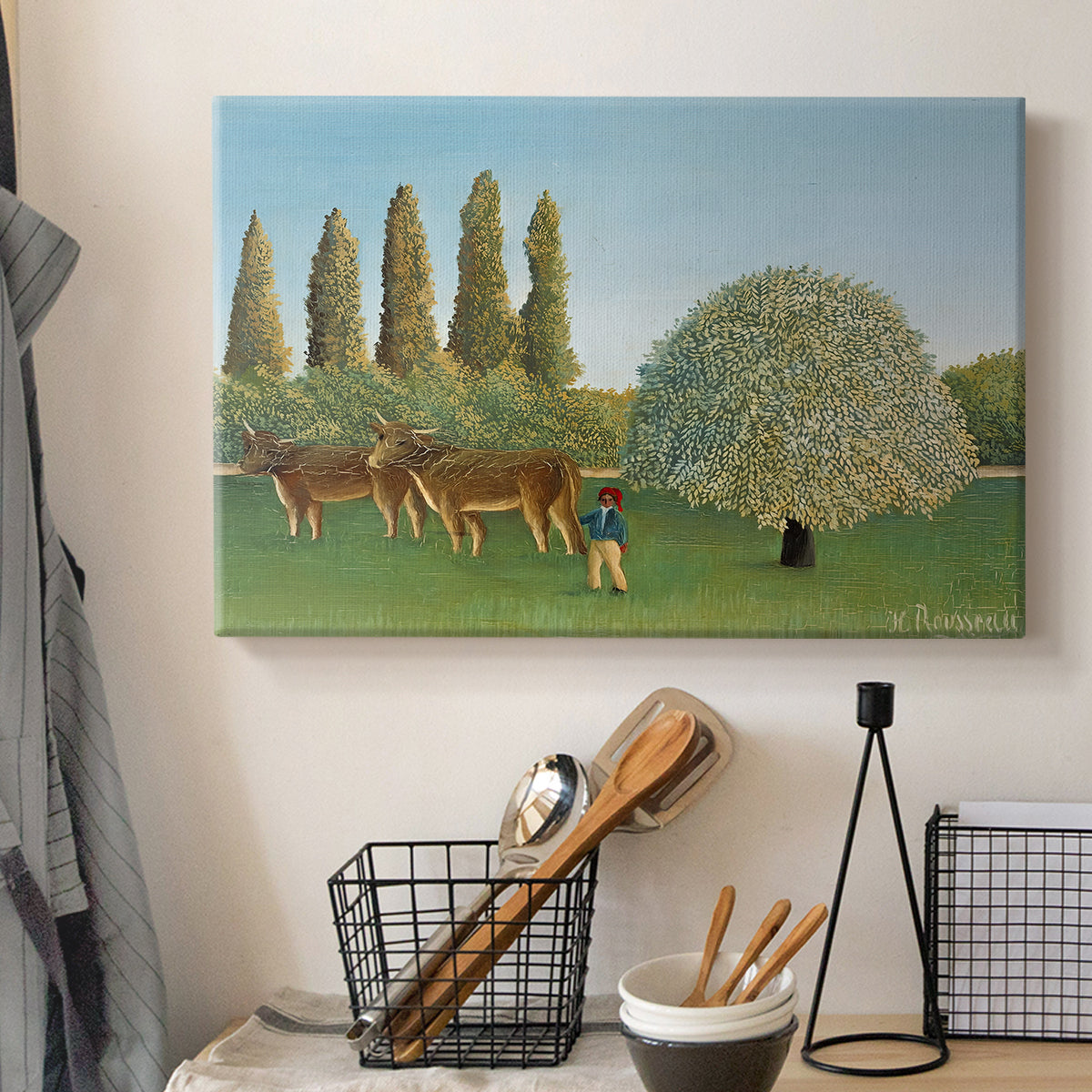 Canvas art print detailing a stylized rural setting with grassland and trees, displayed in a softly lit workspace setting