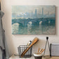 Canvas art print detailing an atmospheric urban landscape with misty light and reflections, displayed in a softly lit workspace setting