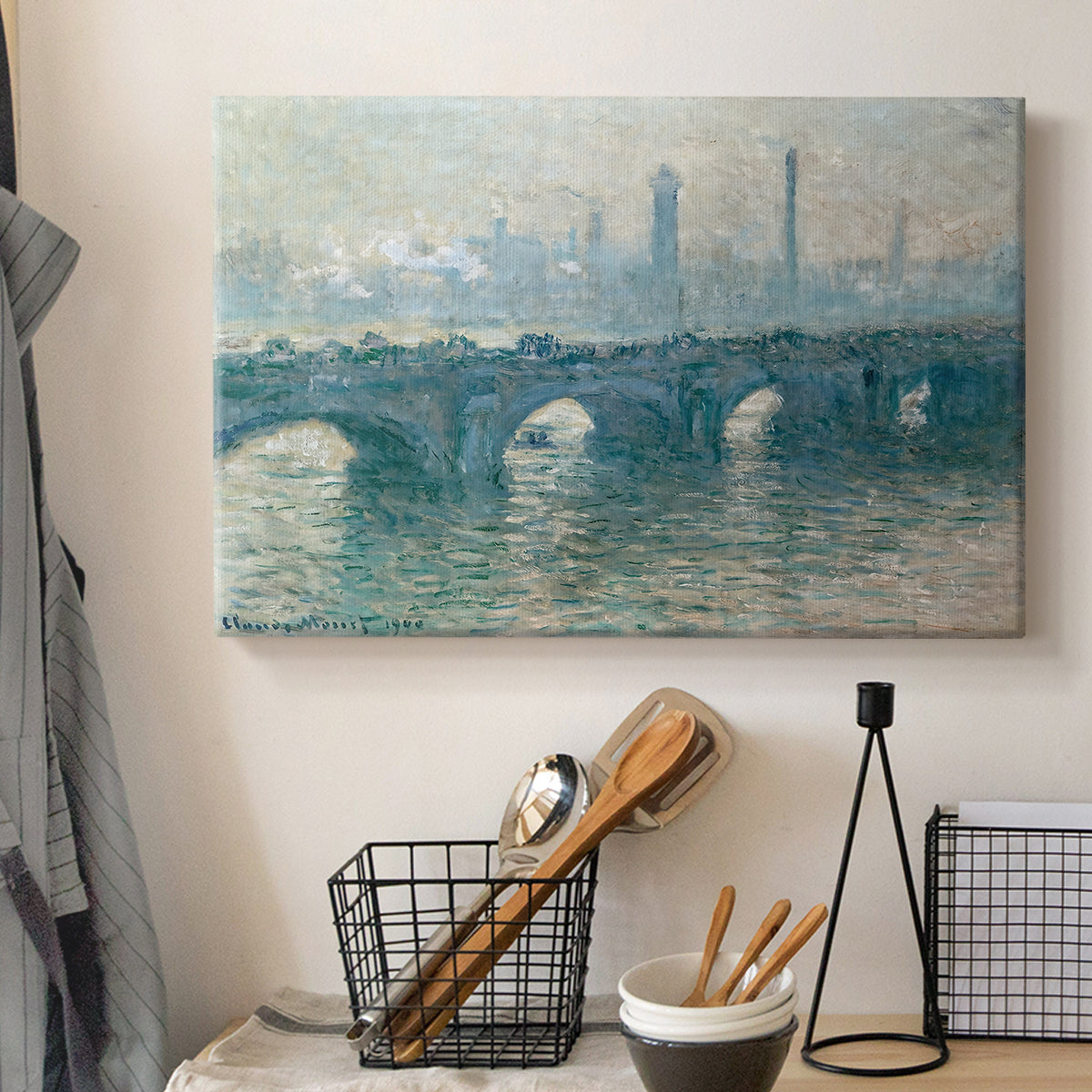 Canvas art print detailing an atmospheric urban landscape with misty light and reflections, displayed in a softly lit workspace setting