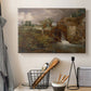 Canvas art print detailing a pastoral view featuring mill, displayed in a softly lit workspace setting